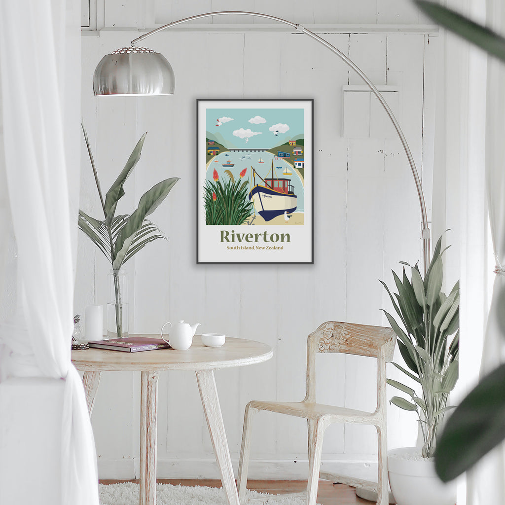 Framed Travel Art Poster in Living room of Riverton, South Island New Zealand. Depicting fishing boats, kiwi batch and the harbour by Illustrator Emma Peers