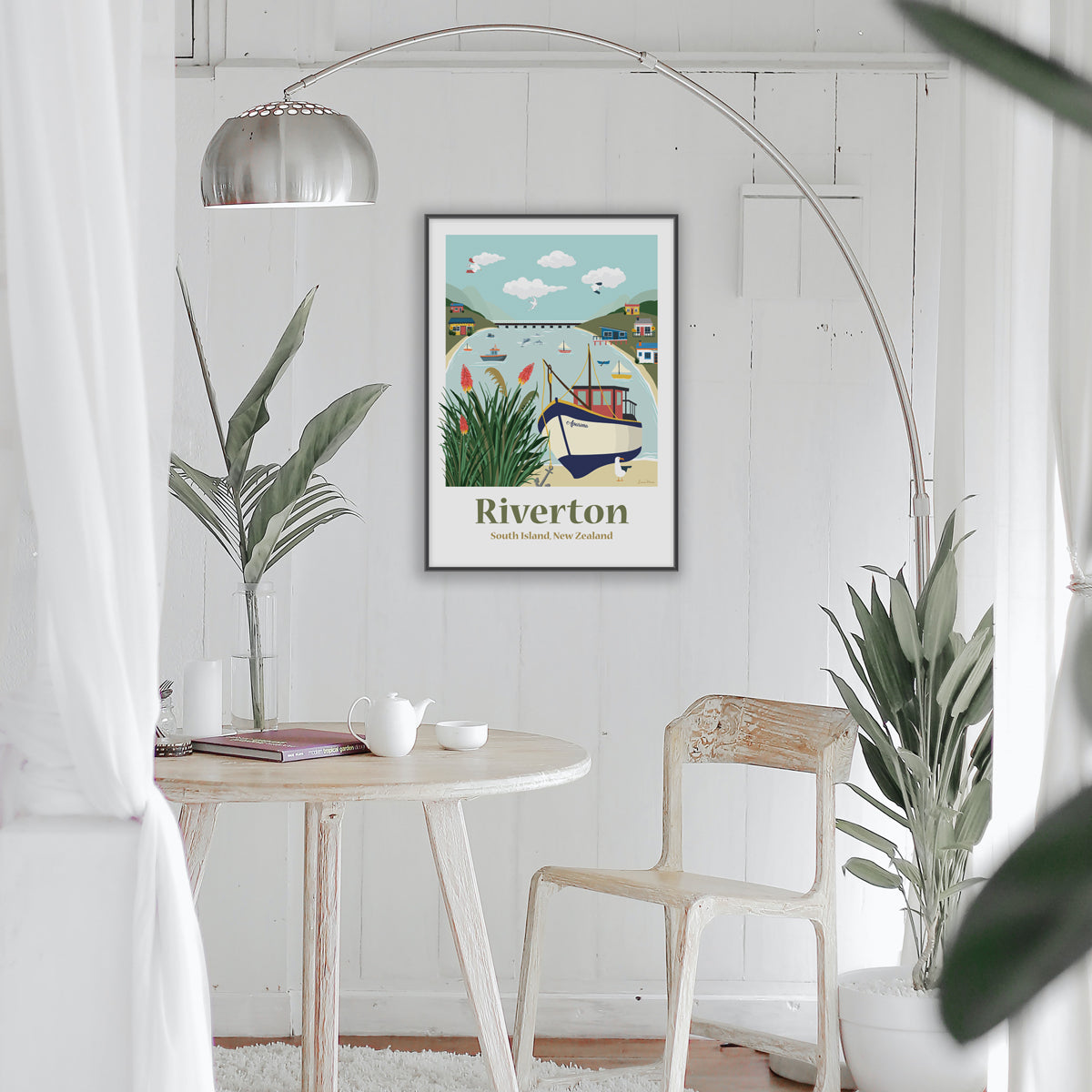 Framed Travel Art Poster in Living room of Riverton, South Island New Zealand. Depicting fishing boats, kiwi batch and the harbour by Illustrator Emma Peers
