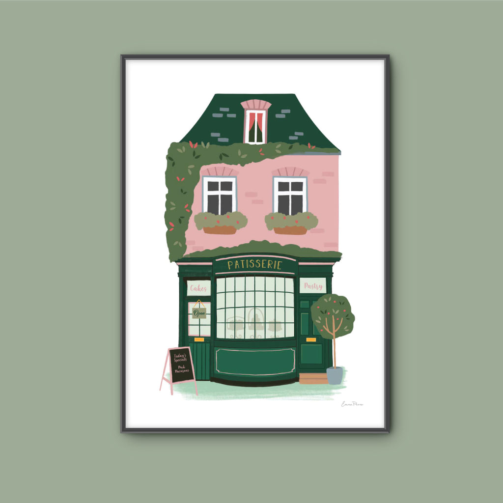 Wall Art Print of Patisserie French Bakery selling cakes and pastries in Parisian street.  Framed mock of pink and green terraced house and shopfront illustrated by Studio Peers